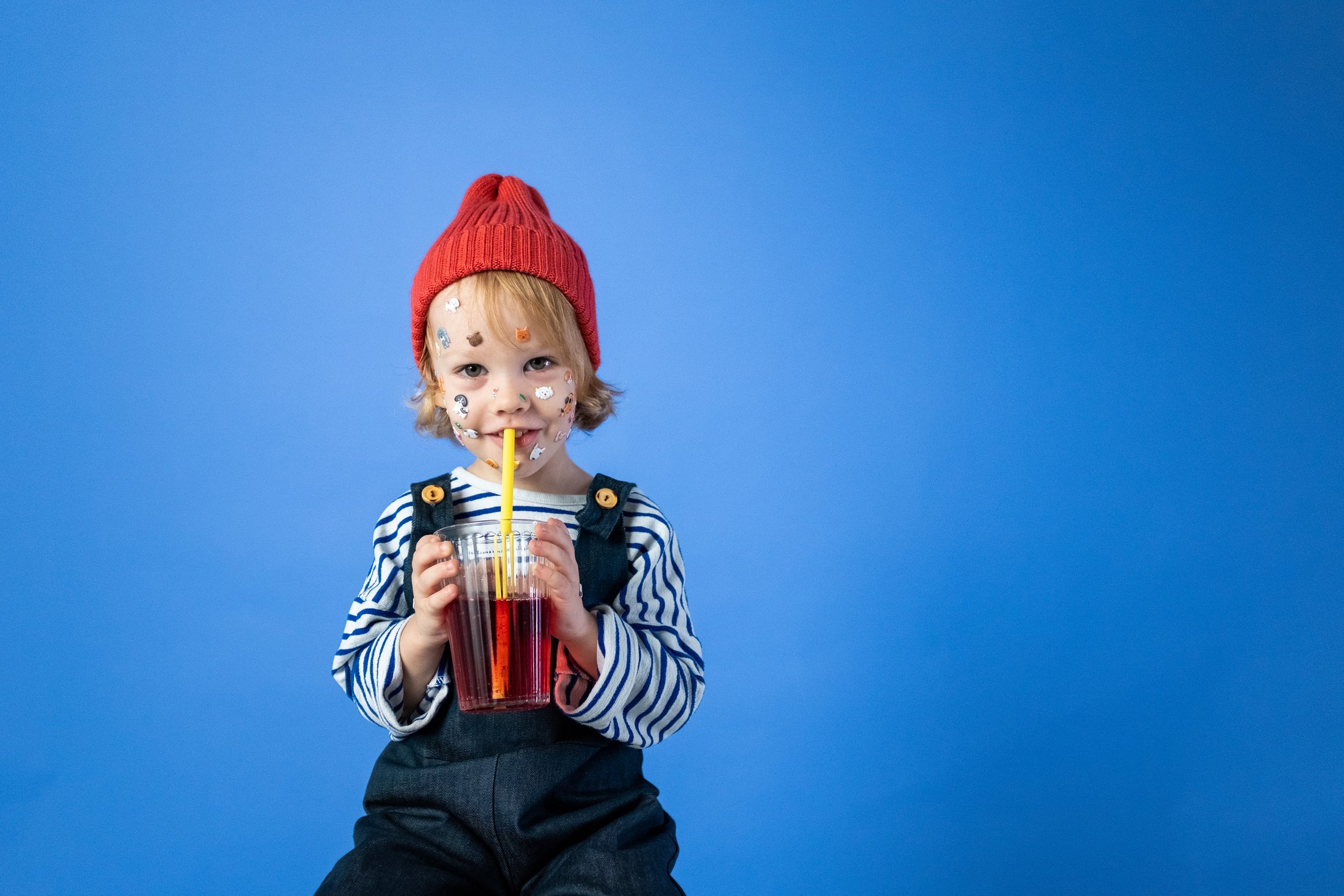 Girl in Red Knit Cap and Striped Long Sleeve Shirt